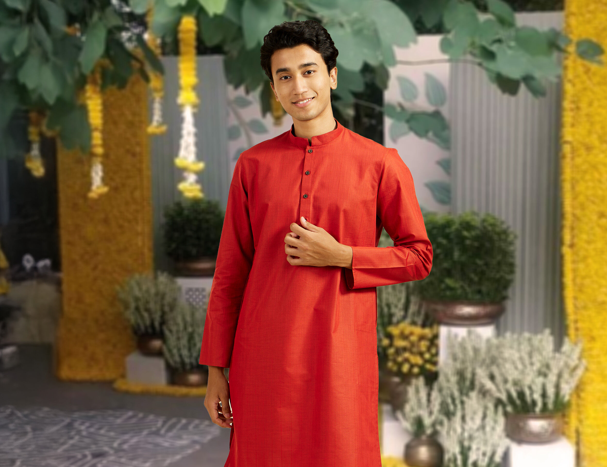 A man wearing traditional red kurta for pongal celebrationn